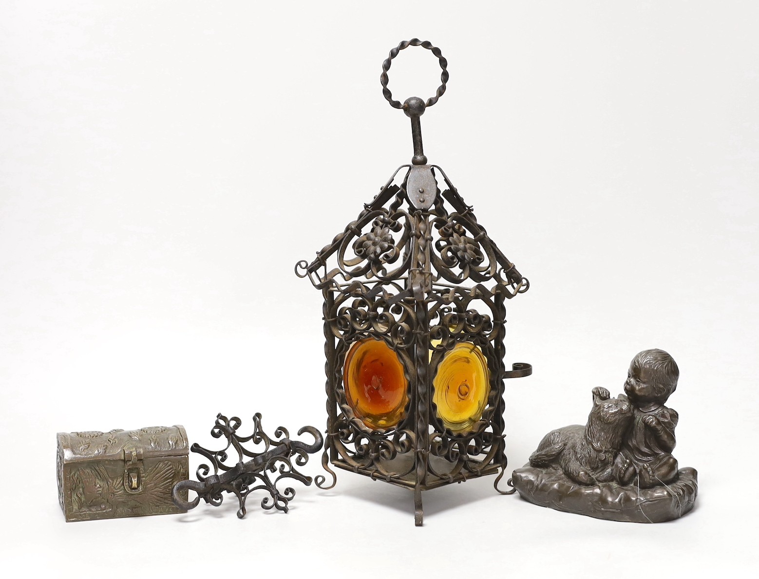 A wrought iron lantern, similar pendant hook, cast miniature brass trunk and bronze effect group, child and dog